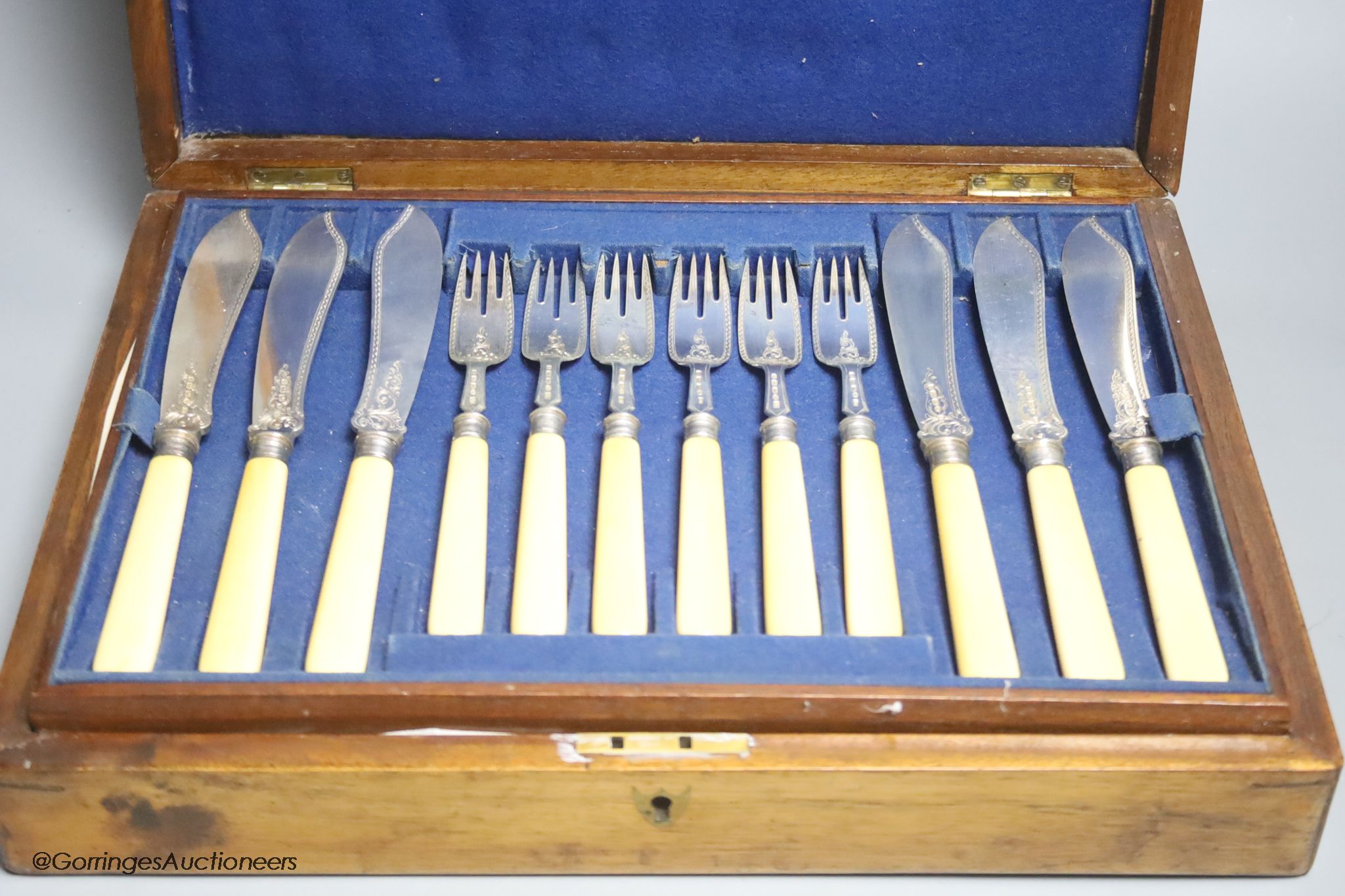 A Victorian cased set of eighteen pairs of ivory handled engraved silver fish eaters by John Gilbert & Co, Birmingham, 1874/5